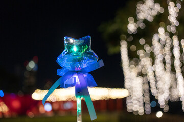 Magic fancy toy luminous star shape LED glow light stick on a bokeh background