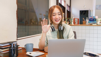Business concept, Woman entrepreneur greeting colleague on video call in coworking space office