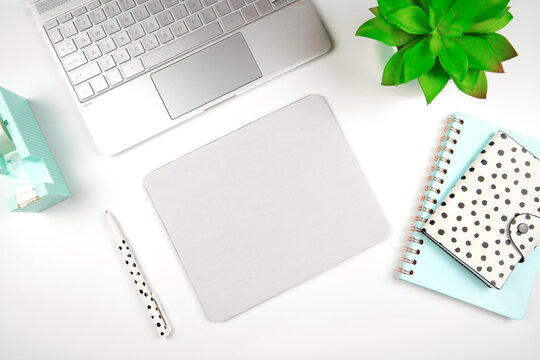 Mouse pad mockup. Styled with computer keyboard and modern desktop accessories. Negative copy space.