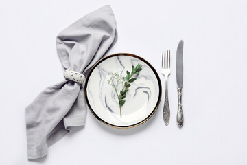 Beautiful table setting and gypsophila flowers on white background