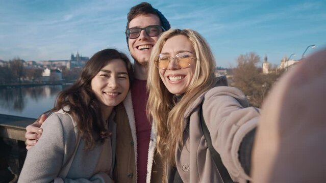 Happy friends taking selfe in Prague. Travel, friendship, youth, millenial, blogger, fame social media concept. Filmed on REd 4k, 10 bit color