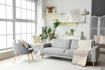 Interior of living room decorated for Birthday party with sofa and armchair