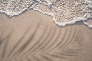 Soft ocean wave on tropical sandy beach in summer
