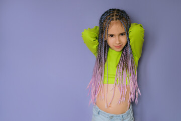 Stylish modern girl with a braided hairstyle with lots of braids of colored strands of artificial hair - obrazy, fototapety, plakaty