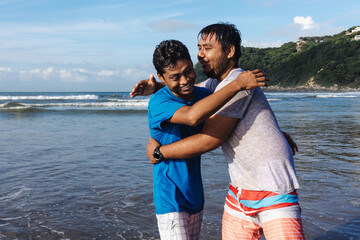 Latin best friends two men having fun at beach in Acapulco Mexico Latin America, hispanic people in...