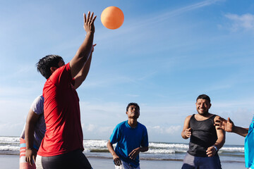 Happy latin friends teenagers at beach playing volleyball at pacific ocean in Acapulco Mexico Latin...