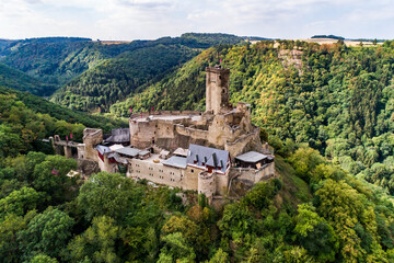 aerial view rock with medieval castle Ehrenburg on it near moselle river in Brodenbach with forest...