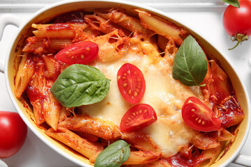Baking dish of pasta with tomato sauce and cheese, closeup