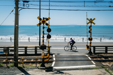 Cyclist Riding Coastline Alongside Railway on a Summers Day 