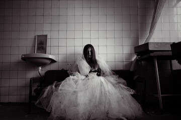 Ghost evil spirit of bride sitting in an armchair in a derelict