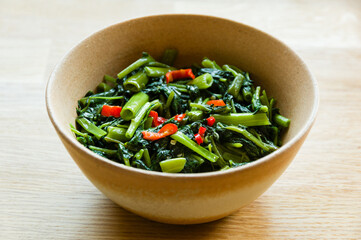 Sri Lankan style stir fried kangkung dish in a bowl