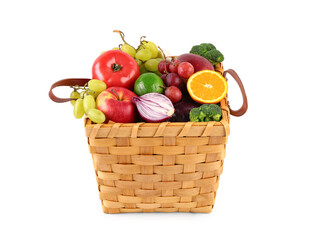 Wicker basket with different fresh fruits and vegetables on white background