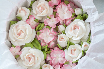 Zephyr bouquet of flowers in a gift box on a light background.