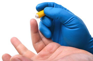 Medic's hand take blood from a finger for analysis