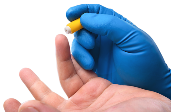 Medic's hand take blood from a finger for analysis