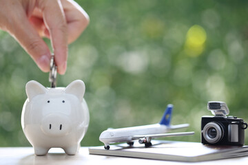 Saving planning for Travel budget of holiday concept, piggy bank and airplane on passport with...