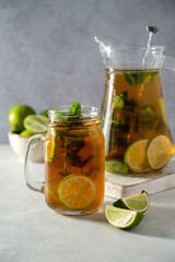 Iced tea with lime and ice in mason jar. Summer refreshing drink.