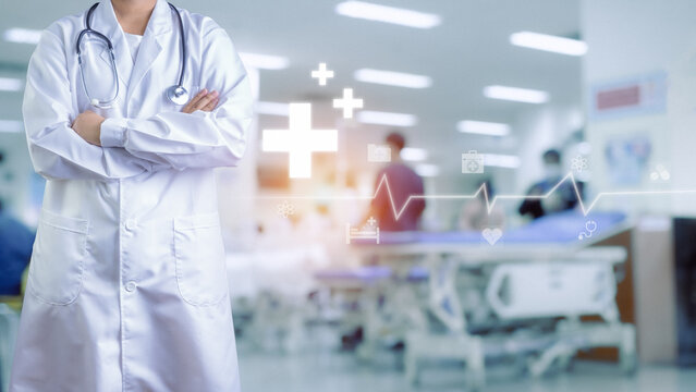 Doctor in lab coat and stethoscope Standing with arms crossed on blurred background inside a hospital. Medical icons . Medical concept. Treatment. Medical technology. medical application
