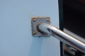 Stainless steel fittings mounted on a blue wall