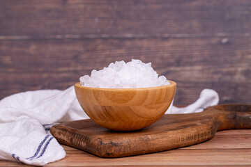 Lemon salt or Citric acid on wood background. Citric acid or lemon salt in wooden bowl