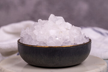 Lemon salt or Citric acid on gray background. Citric acid or lemon salt in bowl