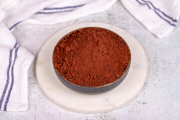 Cocoa powder on gray background. Cocoa powder in bowl