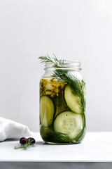Canned cucumbers in a jar on white background, pickles. AI generated