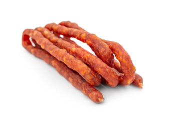 Dried thin meat sausages for beer on a white background.