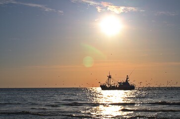 Trawler on the north sea at sunset