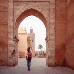 Rear view of woman tourist in Marrakesh, Ilslam door view of Koutoubia mosque- Morocco