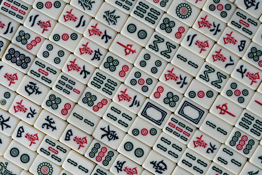 Top Down View Of Many Chinese Mahjong Tiles Background. Traditional Board Game In China