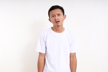 Asian funny man standing with confused face expression. Isolated on white background