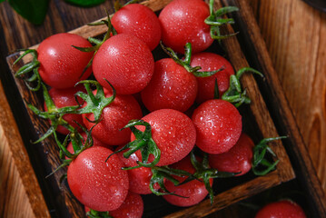 Fresh cherry tomatoes with water drops on the surface, wooden container and wooden tabletop,Cherry Tomato,Lycopersicon lycopersicum var.cerasiforme