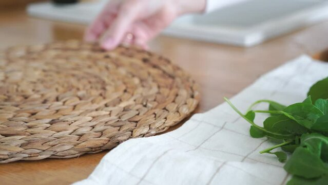 Female hands putting rucola on plate. washed arugula leaves on kitchen towel. High quality 4k footage