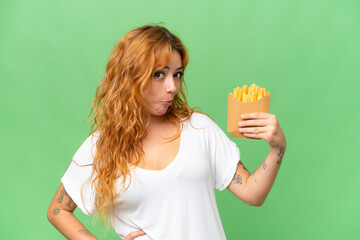 Young caucasian woman holding fried chips isolated on green screen chroma key background