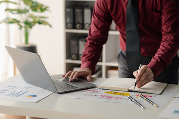 A financier is reviewing company financial documents, monthly financial statement summary from the finance department. The concept of managing the company's finances for accuracy and growth.