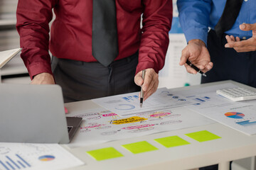 Company meeting room has businessmen and finance managers meeting together on business plan, they are looking at information on documents and discussing together. Concept business planning management.
