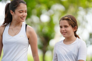 Mother with daughter jogging in park