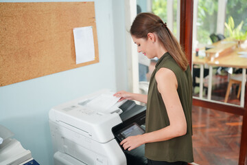 Young Woman Copying Document With Photocopy In Office. Officer copying document with copier machine