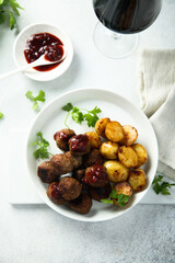 Homemade veal meatballs with potato and berry sauce