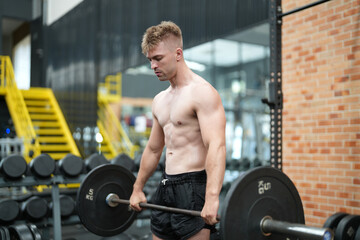Naklejka na ściany i meble Portrait, exercise and man with barbell in gym for fitness, strong muscle power or health. Bodybuilder, training and face of male athlete weightlifting for wellness, sports and serious squat workout.