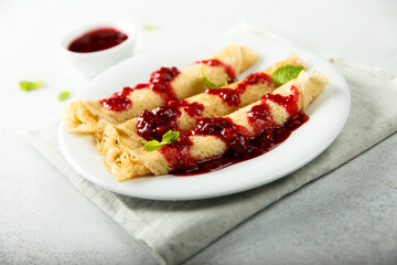 Homemade crepes with raspberry sauce