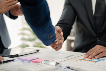 Two businessmen holding hands, Two businessmen are agreeing on business together and shaking hands after a successful negotiation. Handshaking is a Western greeting or congratulation.