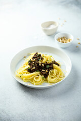 Pasta with olive tapenade and pine nuts