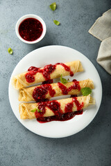 Homemade crepes with raspberry sauce