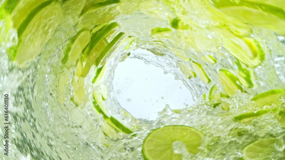 Fototapete super slow motion of water wave with lime slices. water surf wave rotating around in creating tunnel