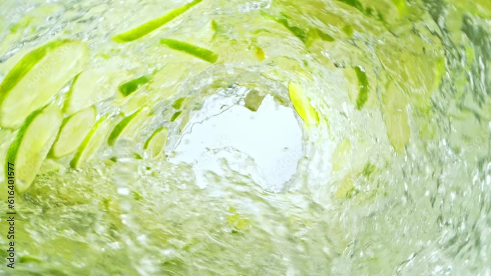 Leinwandbilder super slow motion of water wave with lime slices. water surf wave rotating around in creating tunnel