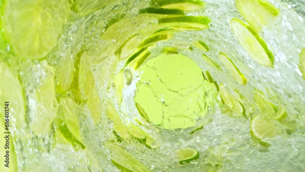 Fototapete Super Slow Motion of Water Wave with Lime Slices. Water Surf Wave Rotating Around in Creating Tunnel Shape. Filmed on high speed cinema camera, 1000 fps. Speed Ramp Effect.