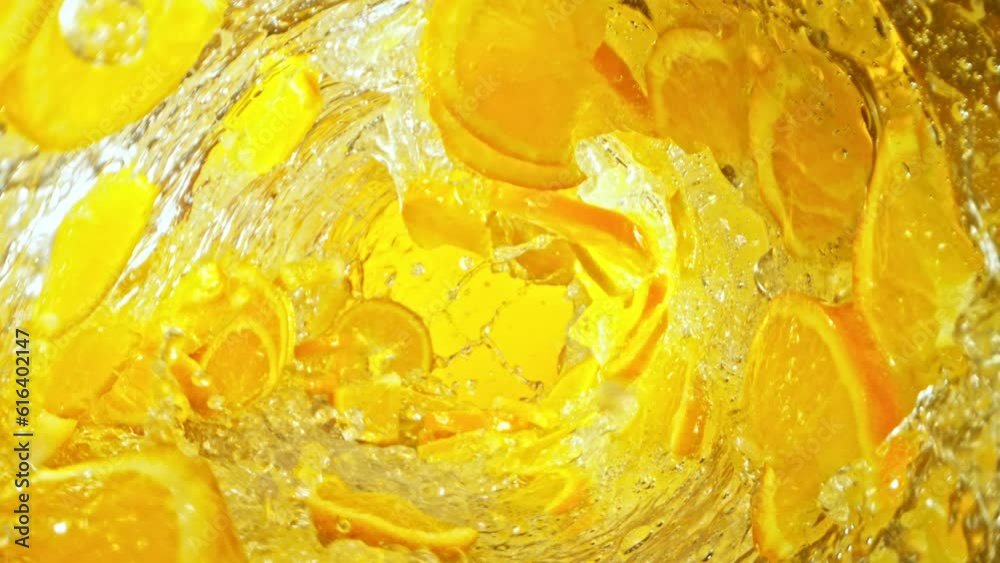 Leinwandbilder super slow motion of water wave with orange slices. water surf wave rotating around in creating tunn