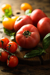 Fresh ripe tomatoes on a wooden desk
